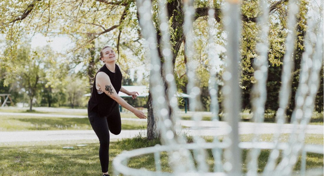Person golfing on sunny day