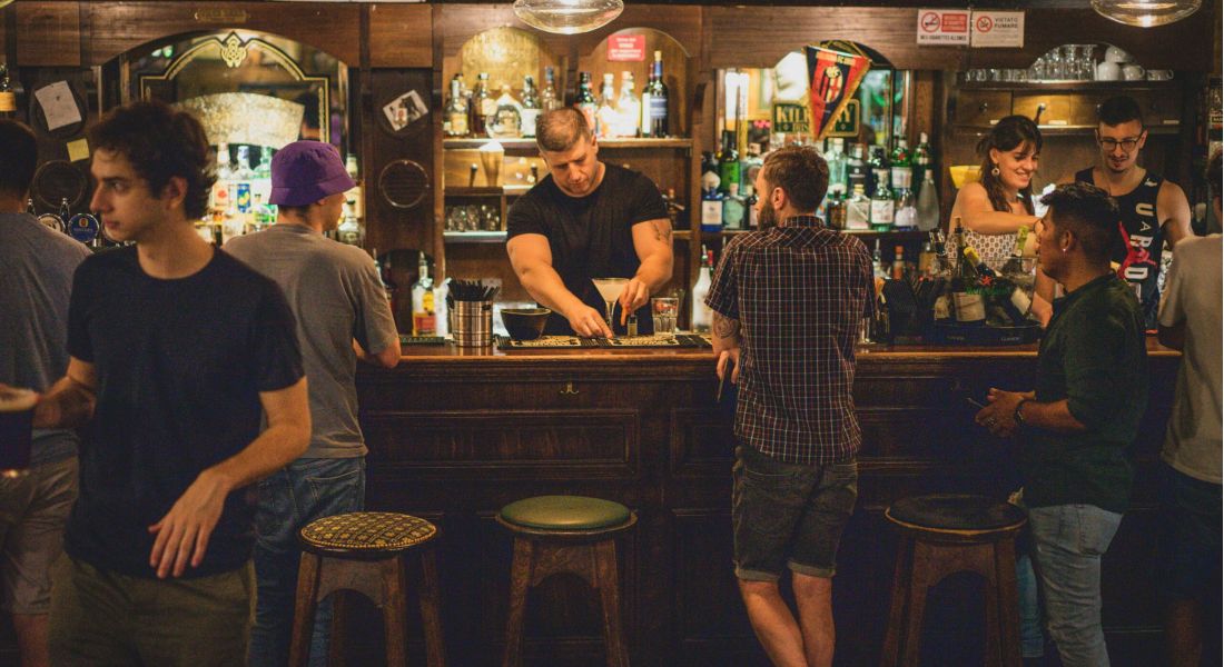 Bartender at local bar pouring a cocktail